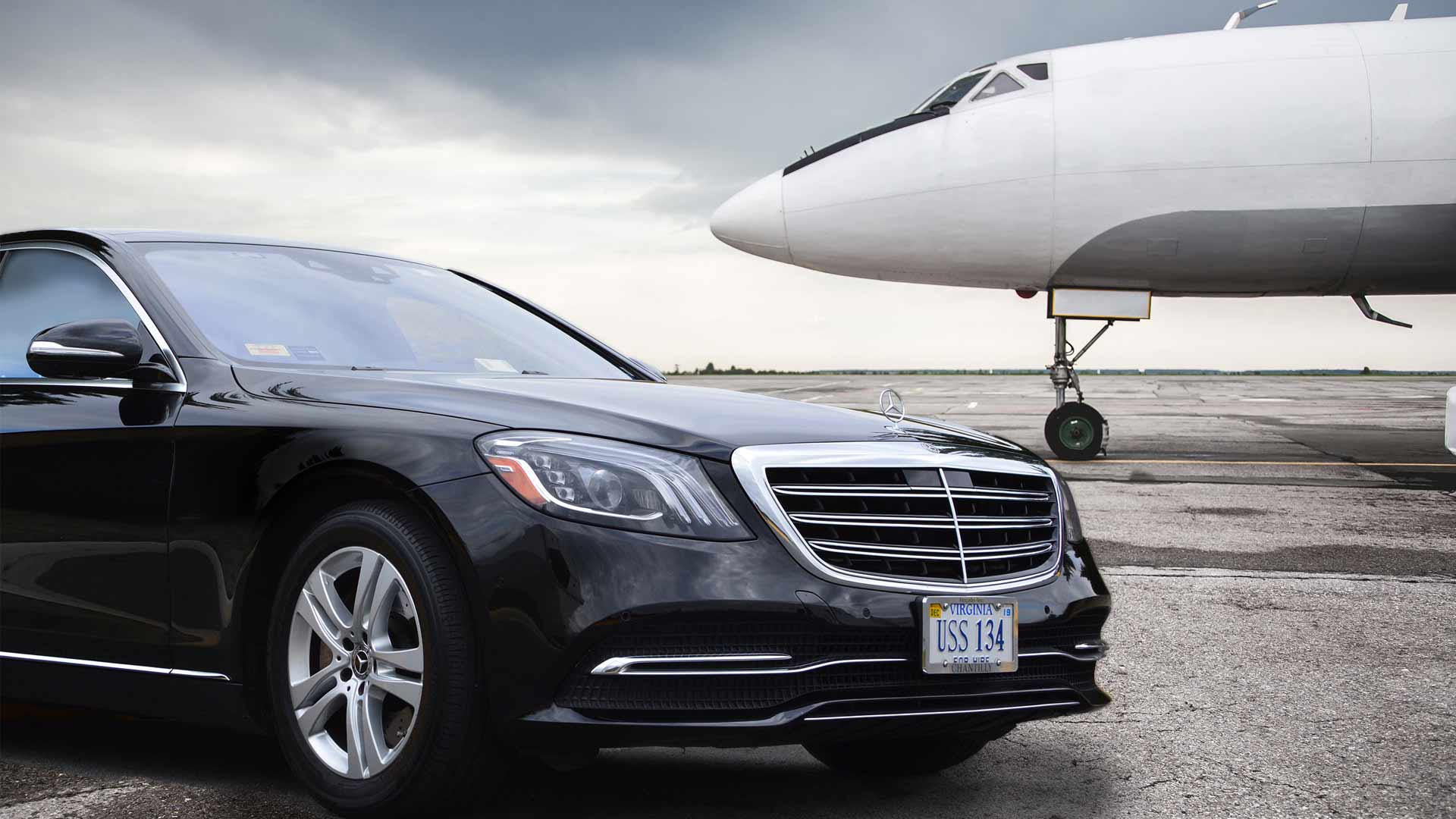 Chauffeured Sedan parked next to private plane
